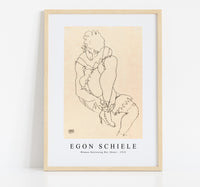 Egon Schiele - Woman Buttoning Her Shoes 1915